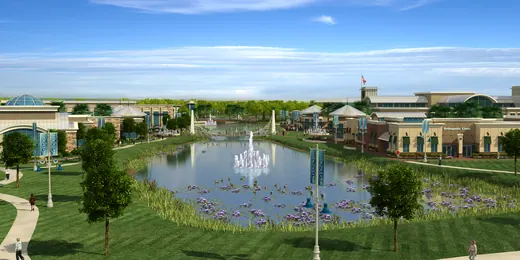 Ground-level rendering of buildings and walkways around a landscaped lake